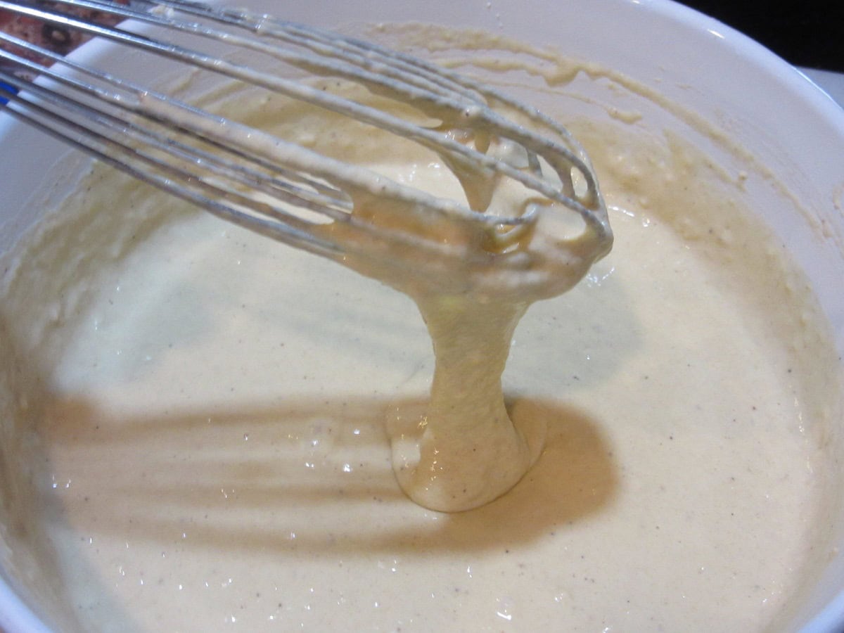 A whisk showing the consistency of spaetzle dough.