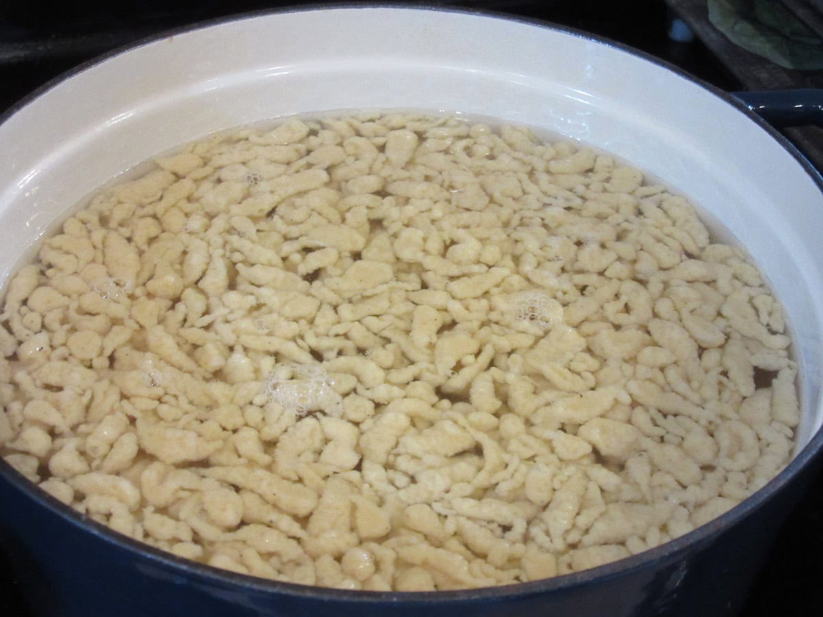 Cooked spaetzle in a pot with water.
