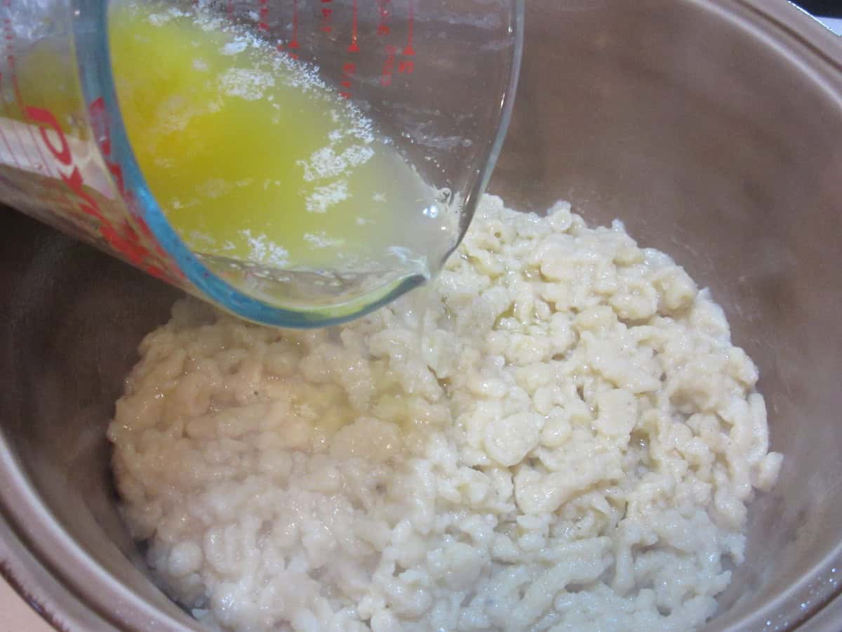 Butter being poured into a casserole dish.