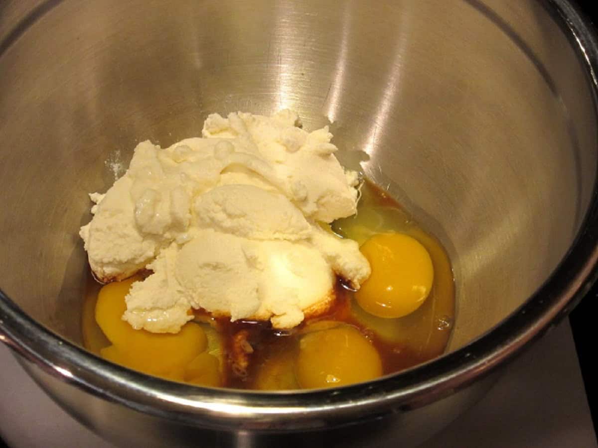 Eggs and ricotta cheese in a large bowl.