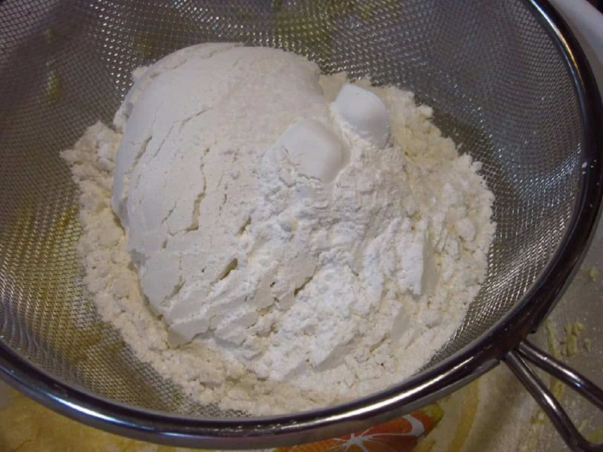 Flour in a fine mesh strainer.
