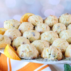 Puffy Orange and Cranberry Ricotta Cookies glazed with orange zest and sugar.