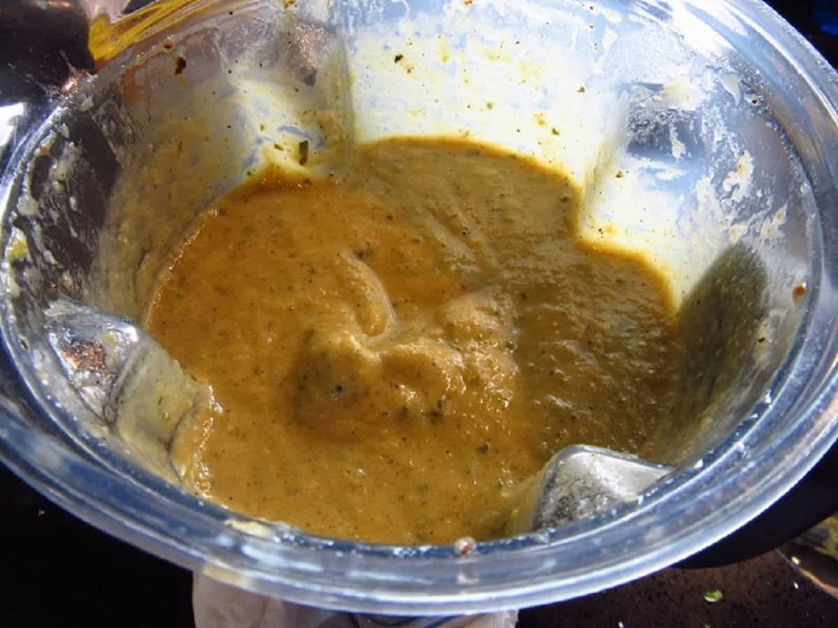 A creamy garlic and zucchini soup in a blender.