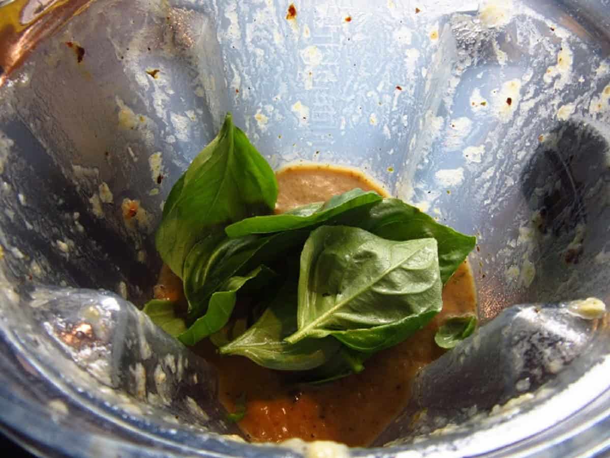 Fresh basil in a blender making soup.