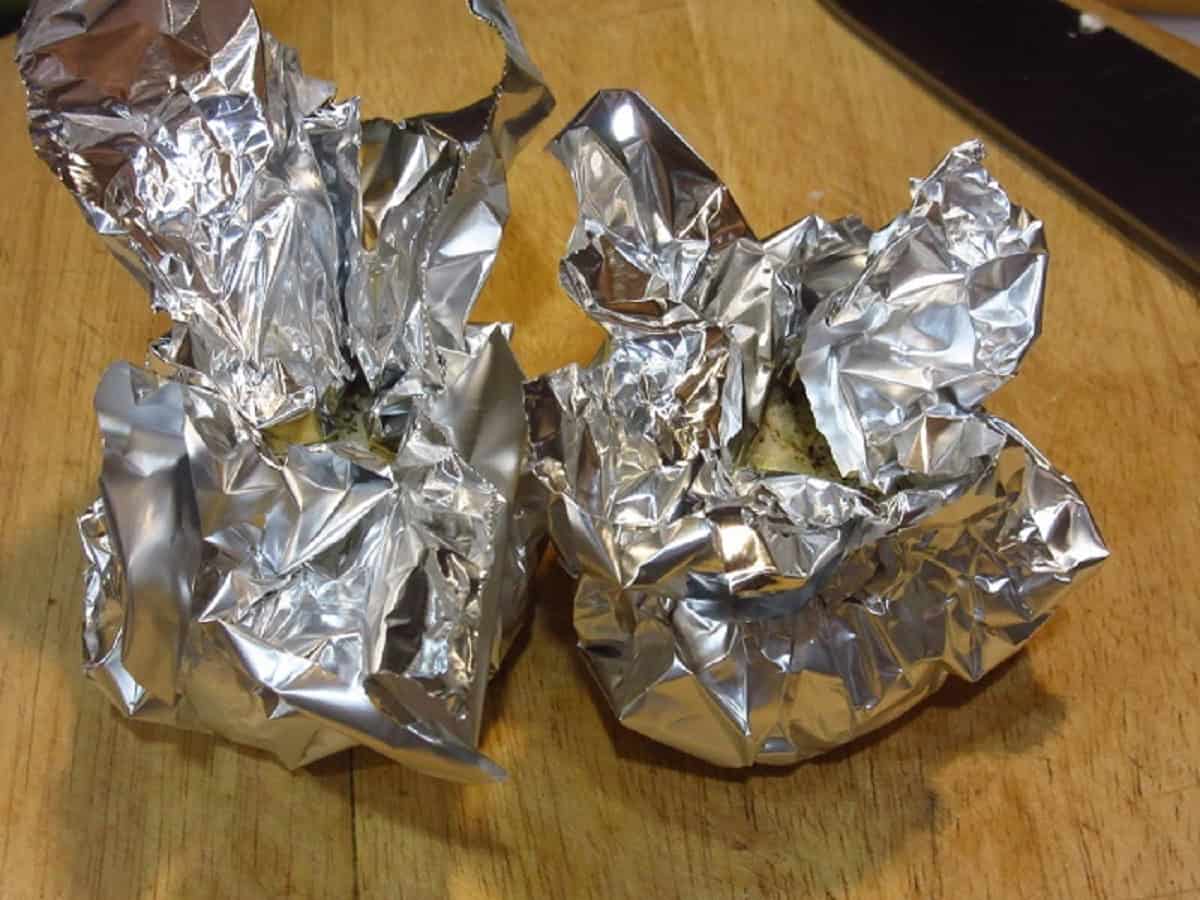 Foil wrapped garlic bulbs ready for roasting.