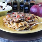 A hearty slice of Mexican Turkey Taco Lasagna on a yellow plate with a fork.