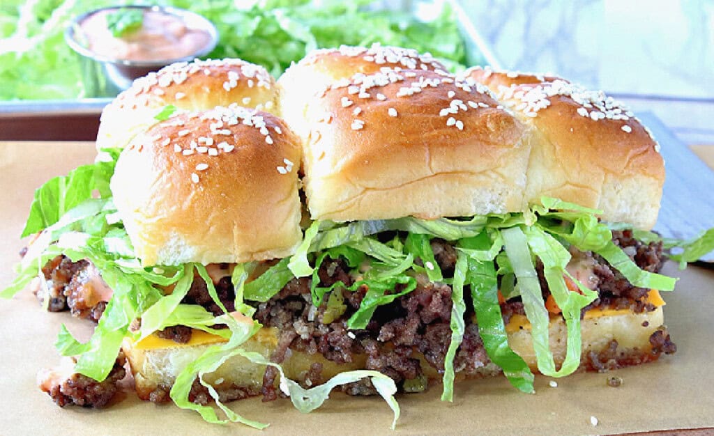 A collection of delicious Big Mac Sliders with cheese, lettuce, and sesame seed buns.