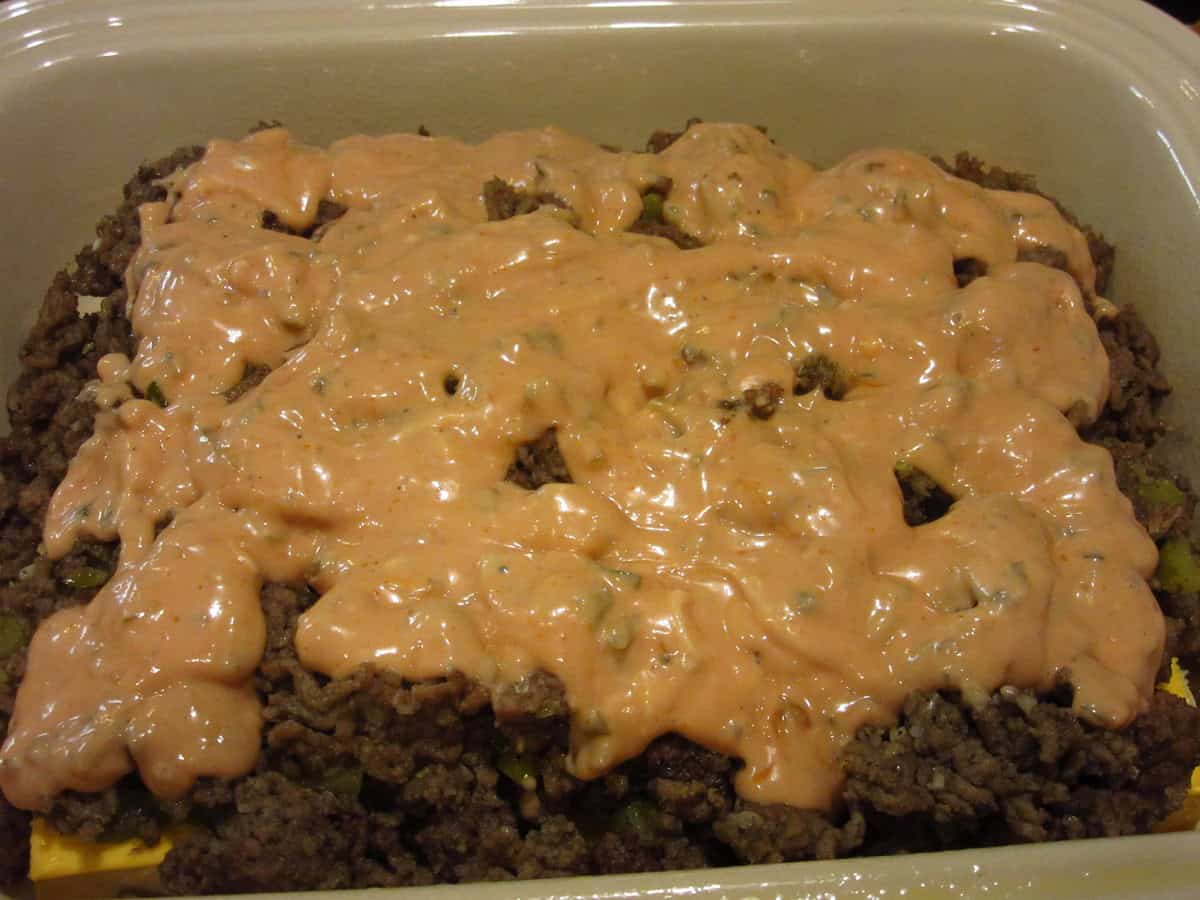 Special sauce over the top of ground beef.