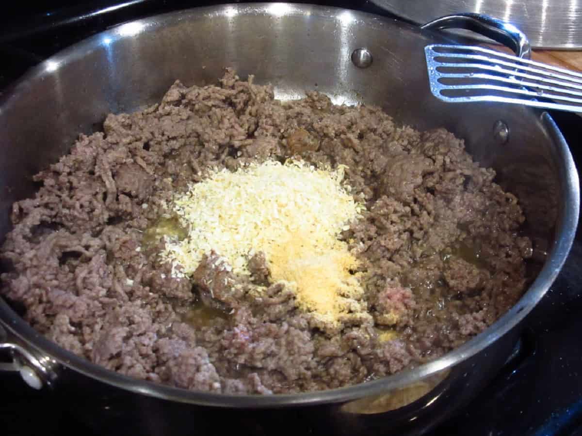 Dried onions in a skillet with browned ground beef.