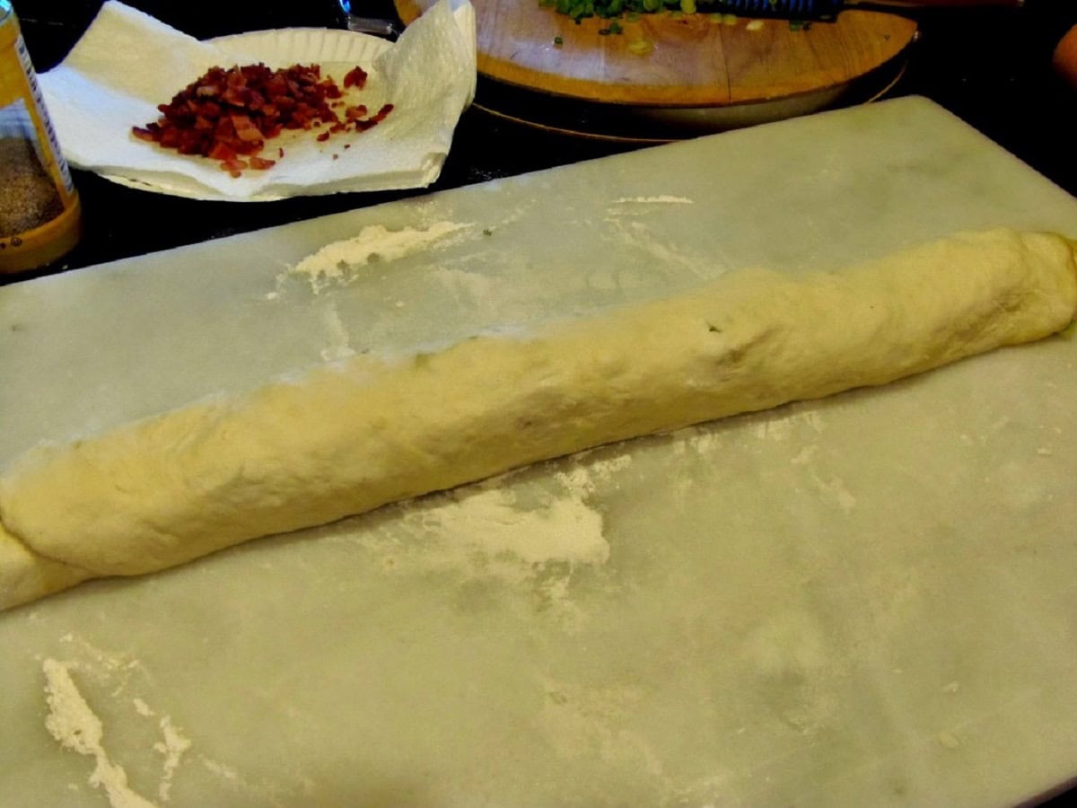 A long roll of Chinese Bring bread before coiling.