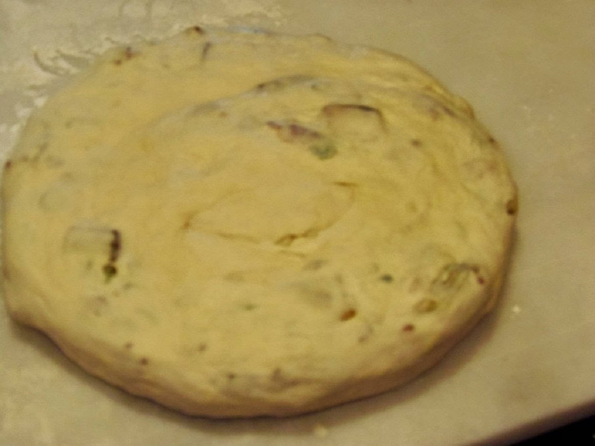 An unbaked Chinese Bing Bread on a white marble slab.