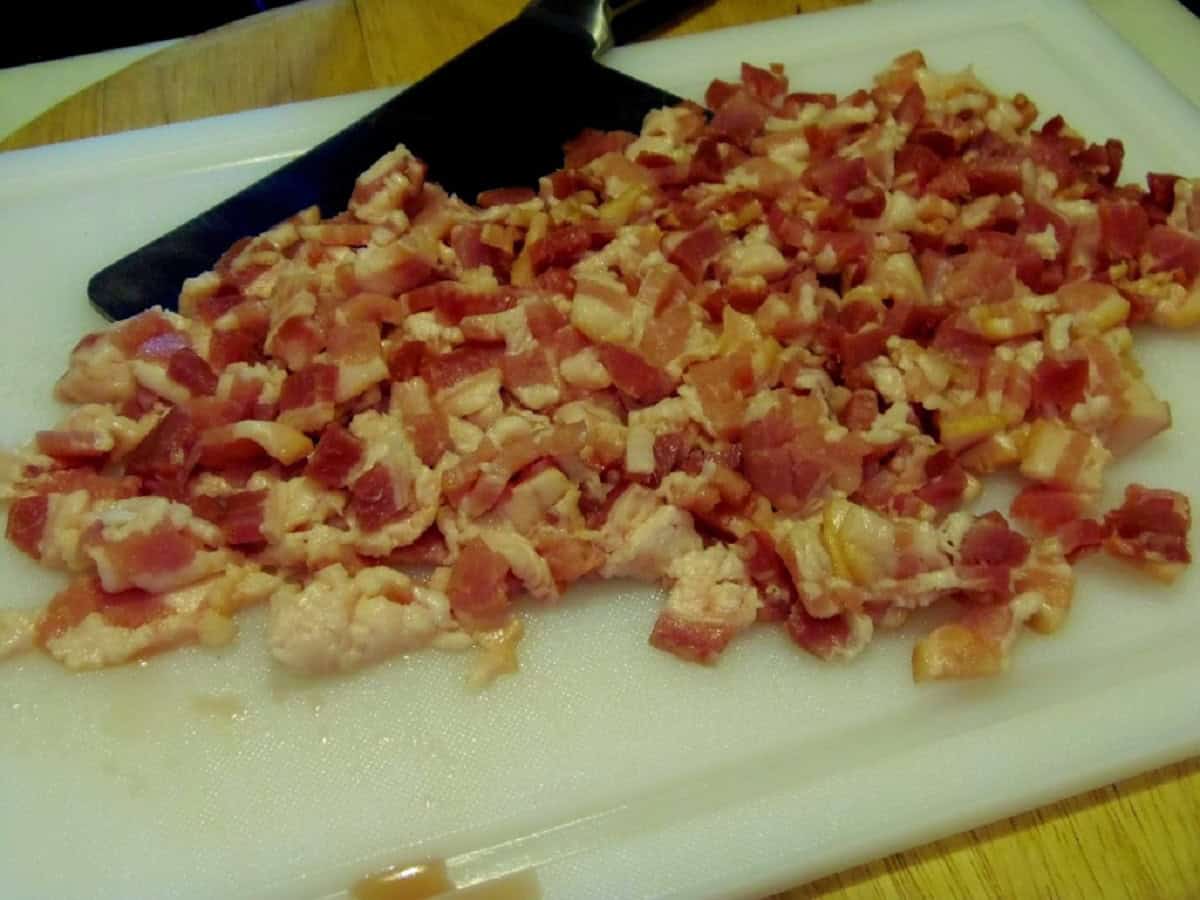 Chopped bacon on a cutting board.