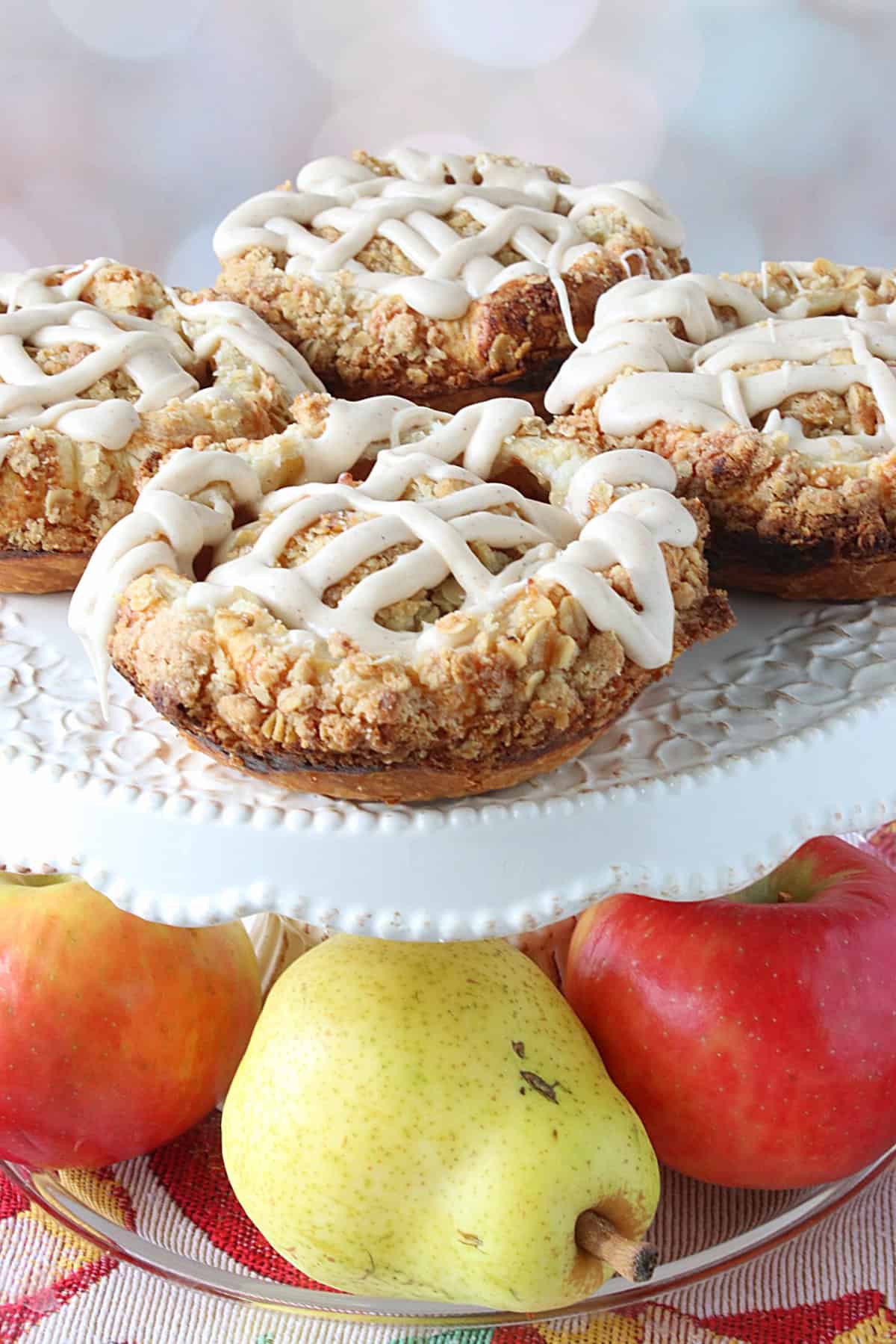 A pretty display of Apple and Pear Blossoms on a cake stand with real fruit under the stand.