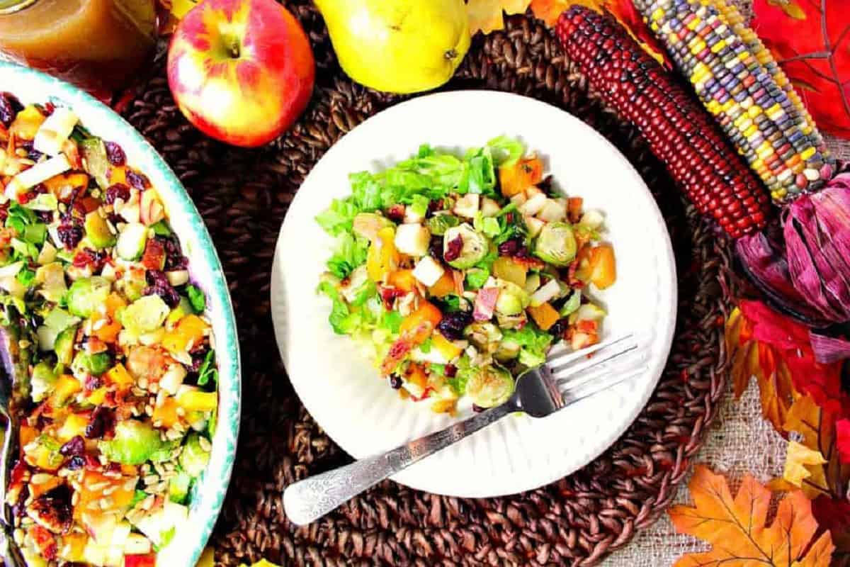A serving of colorful Chopped Fall Salad on a plate with a fork.