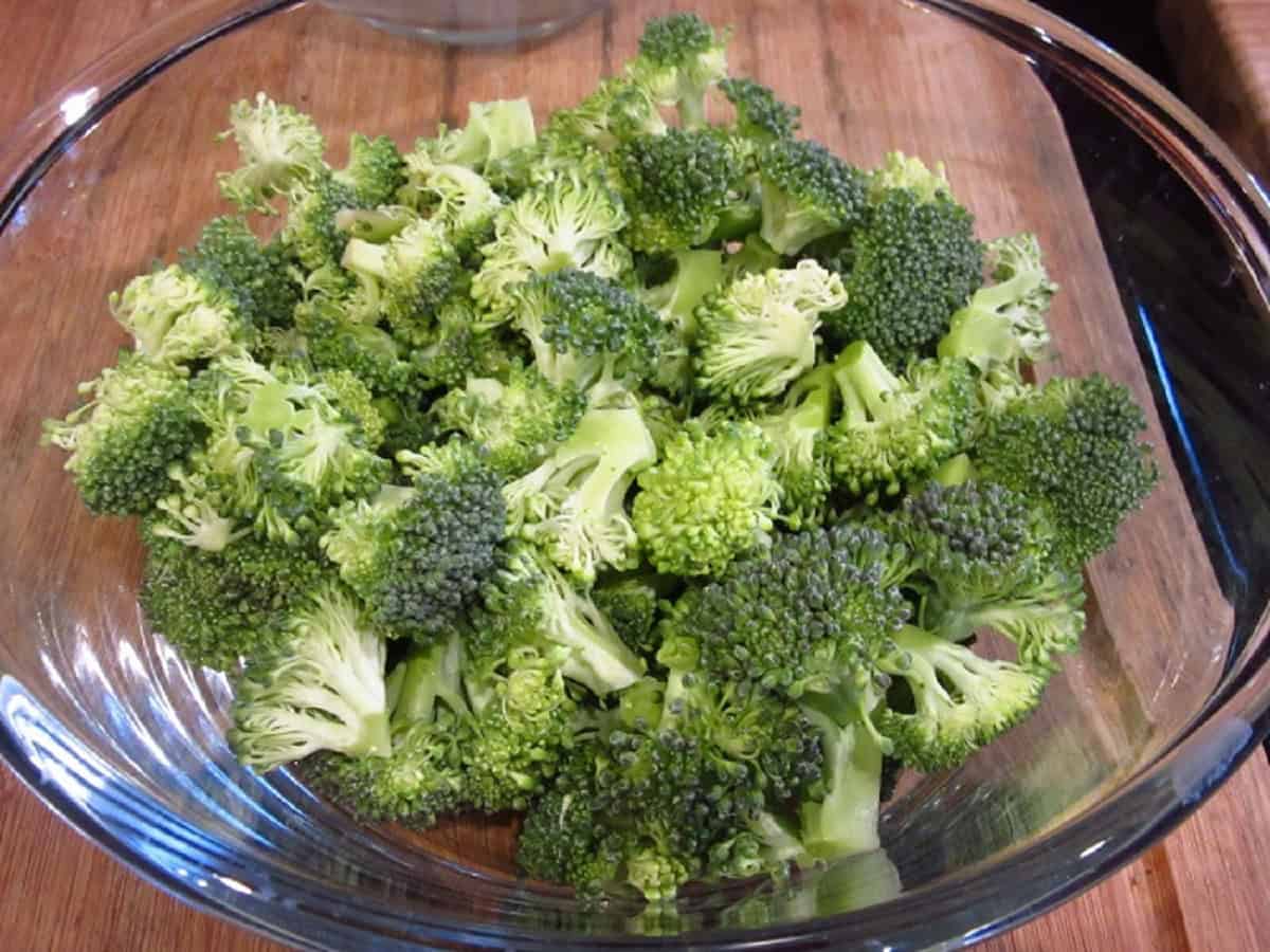 Broccoli florets in a glass bowl.