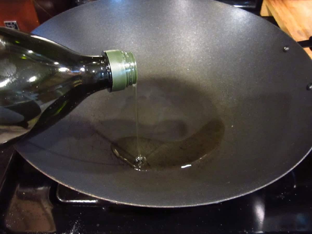 Oil being poured into a wok.