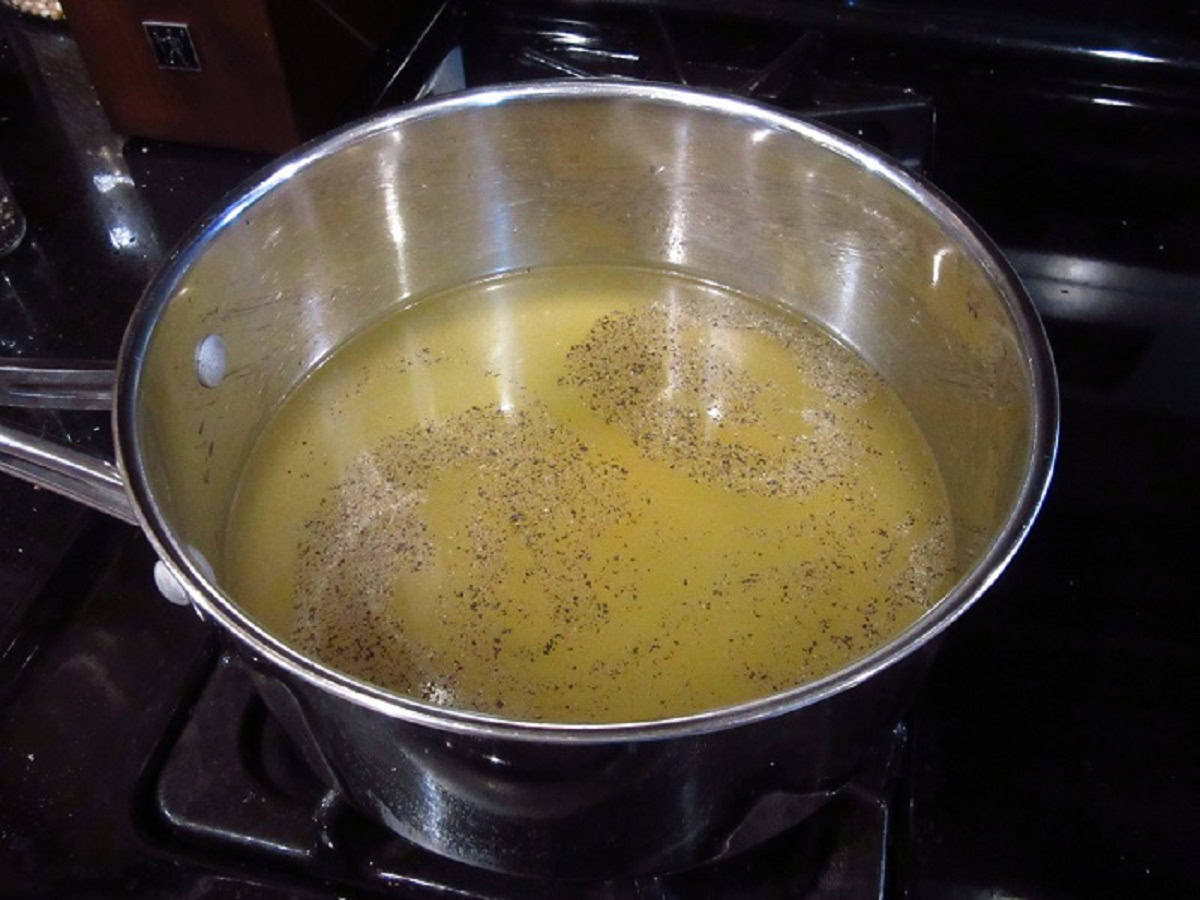 Broth and spices in a saucepan.