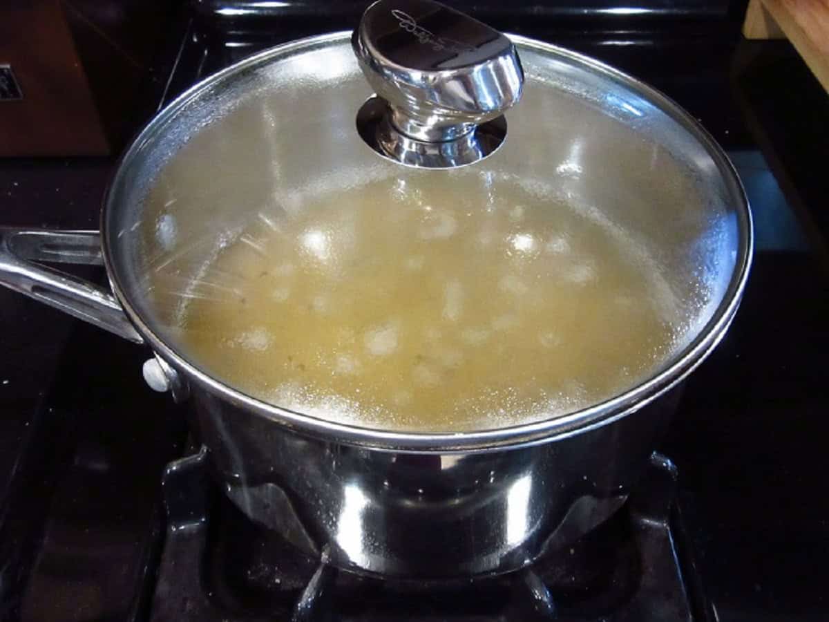 Broth in a covered saucepan.