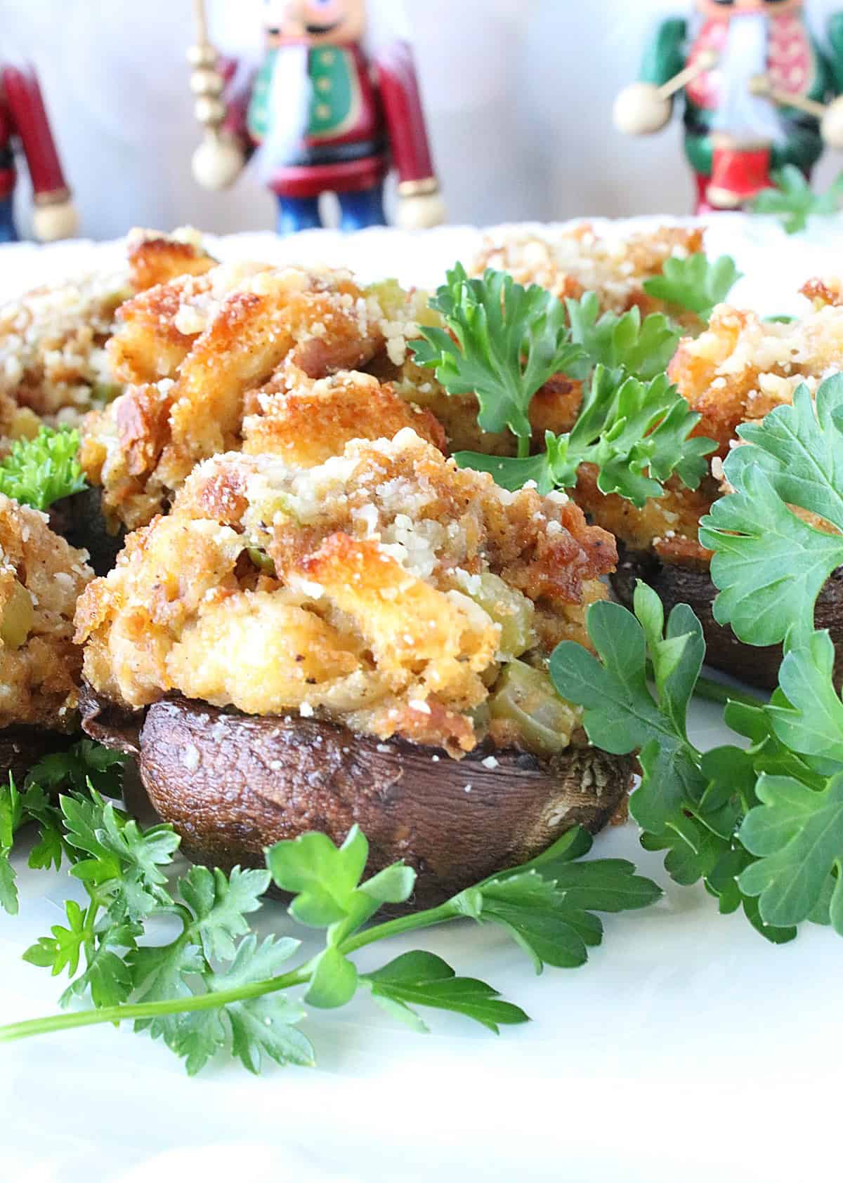 A baked cremini mushroom cap stuffed with bread stuffing as an appetizer.