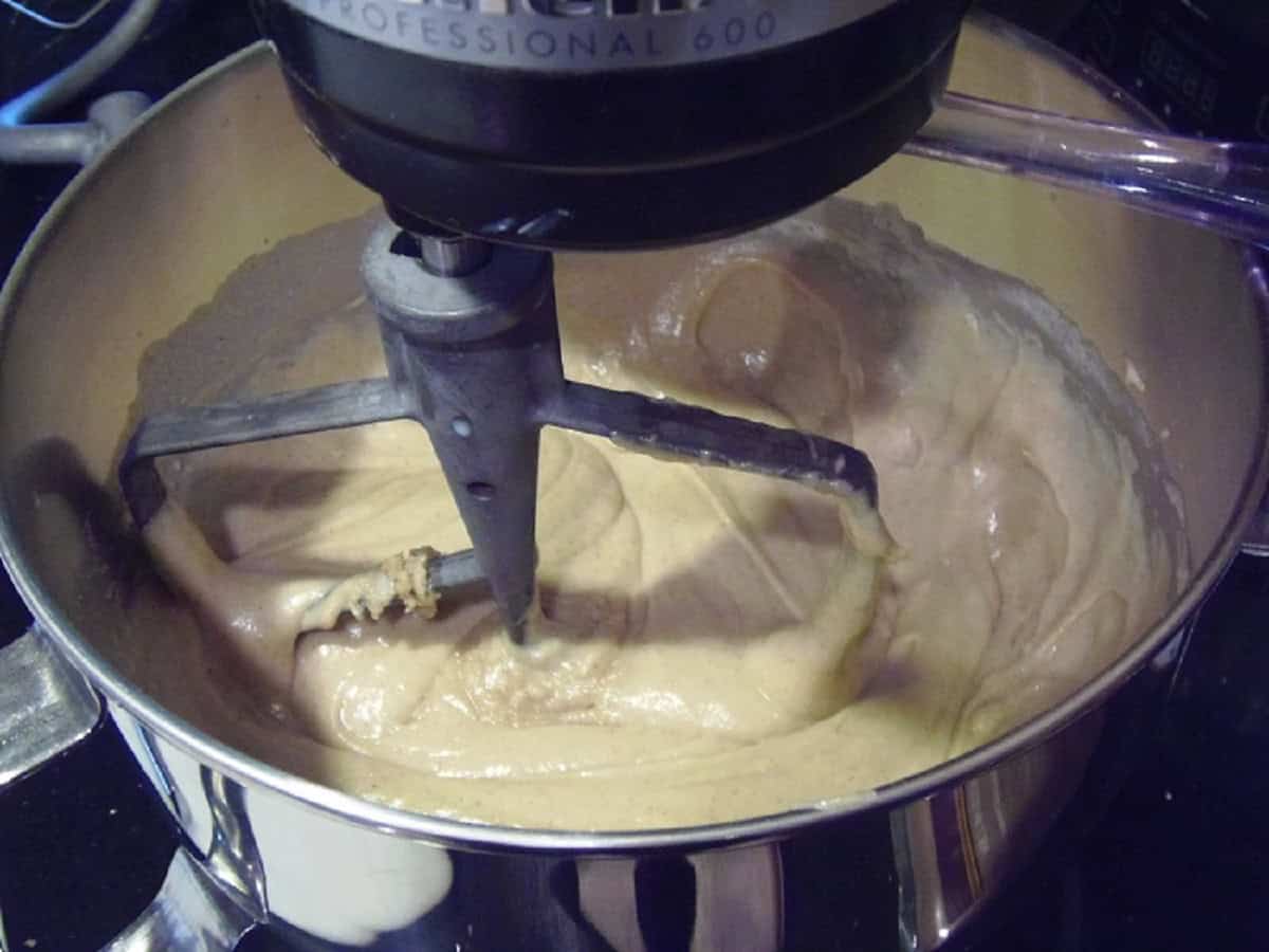 A cupcake batter in a stand mixer with the paddle attachment.
