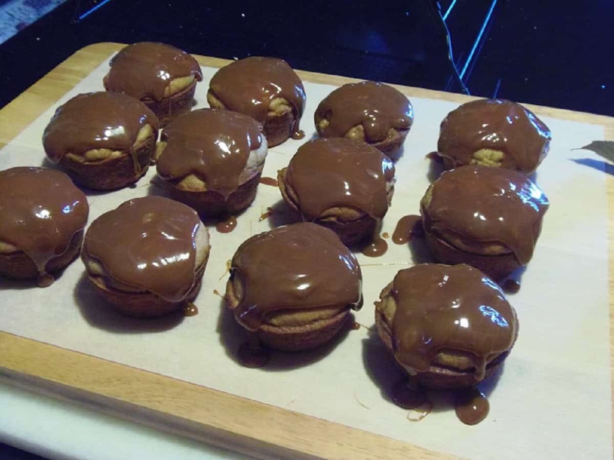 Caramel over baked cupcakes on the countertop.