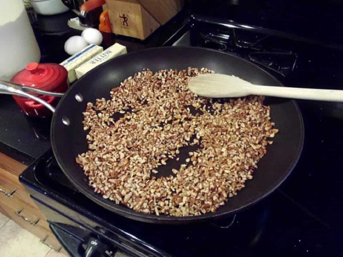 Toasting nuts in a skillet on the stovetop.