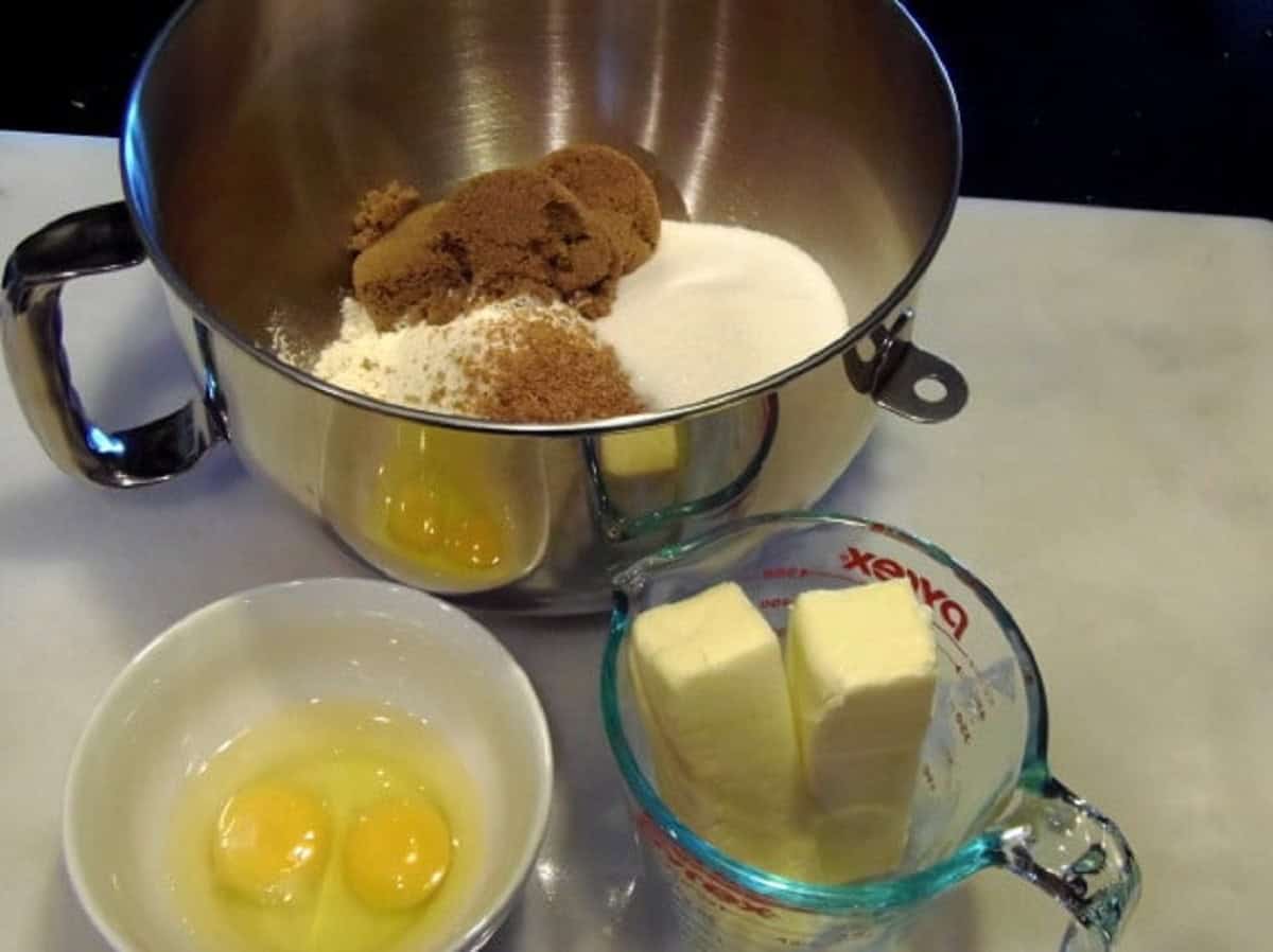 The separate ingredients for making Caramel Apple Cupcakes in bowls on the counter.