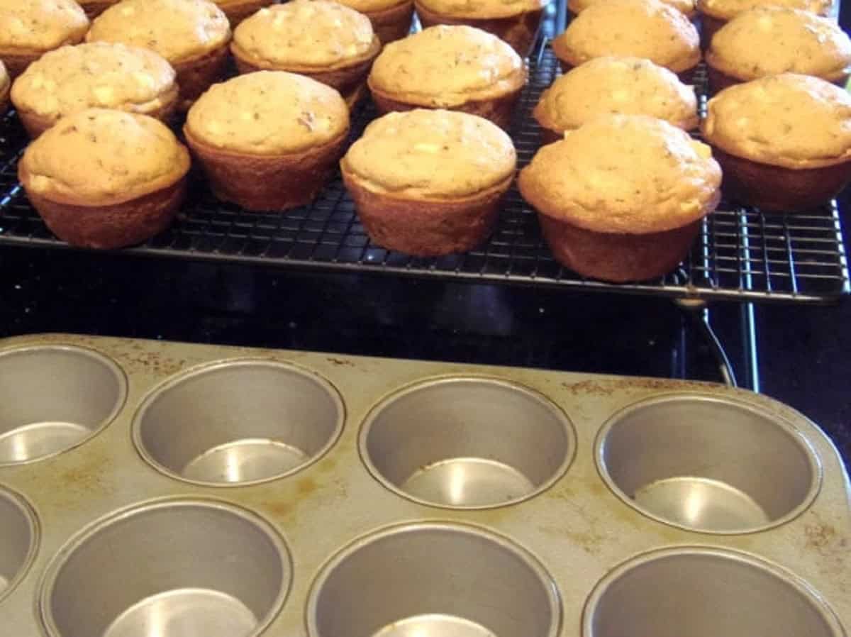 Caramel apple cupcakes on a cooling rack right out of the oven.