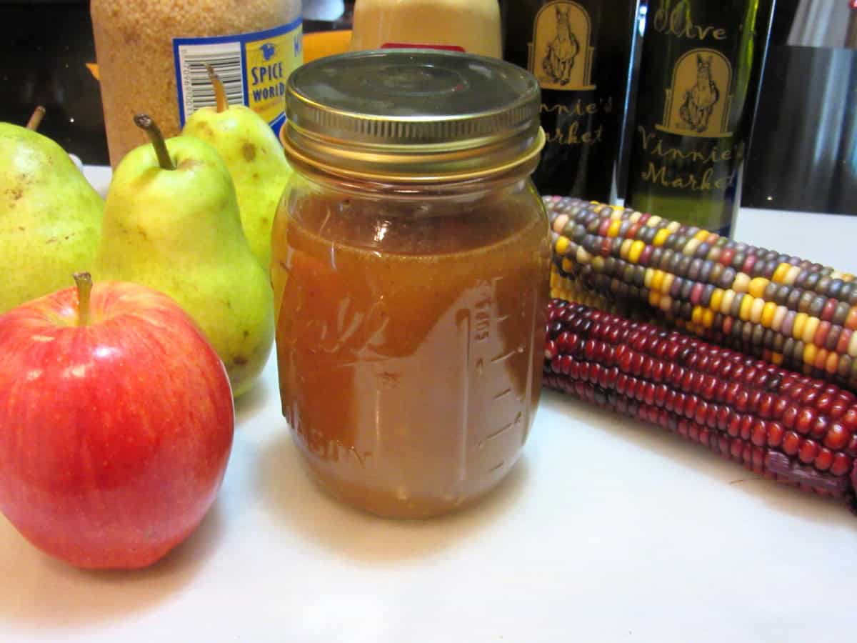A homemade pumpkin vinaigrette in a mason jar on the counter.
