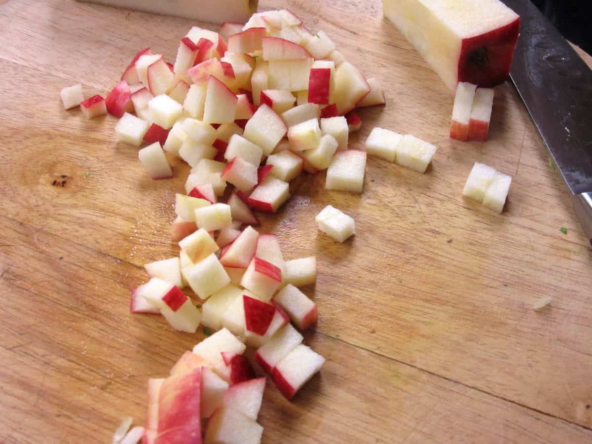 Diced apples on a cutting board.