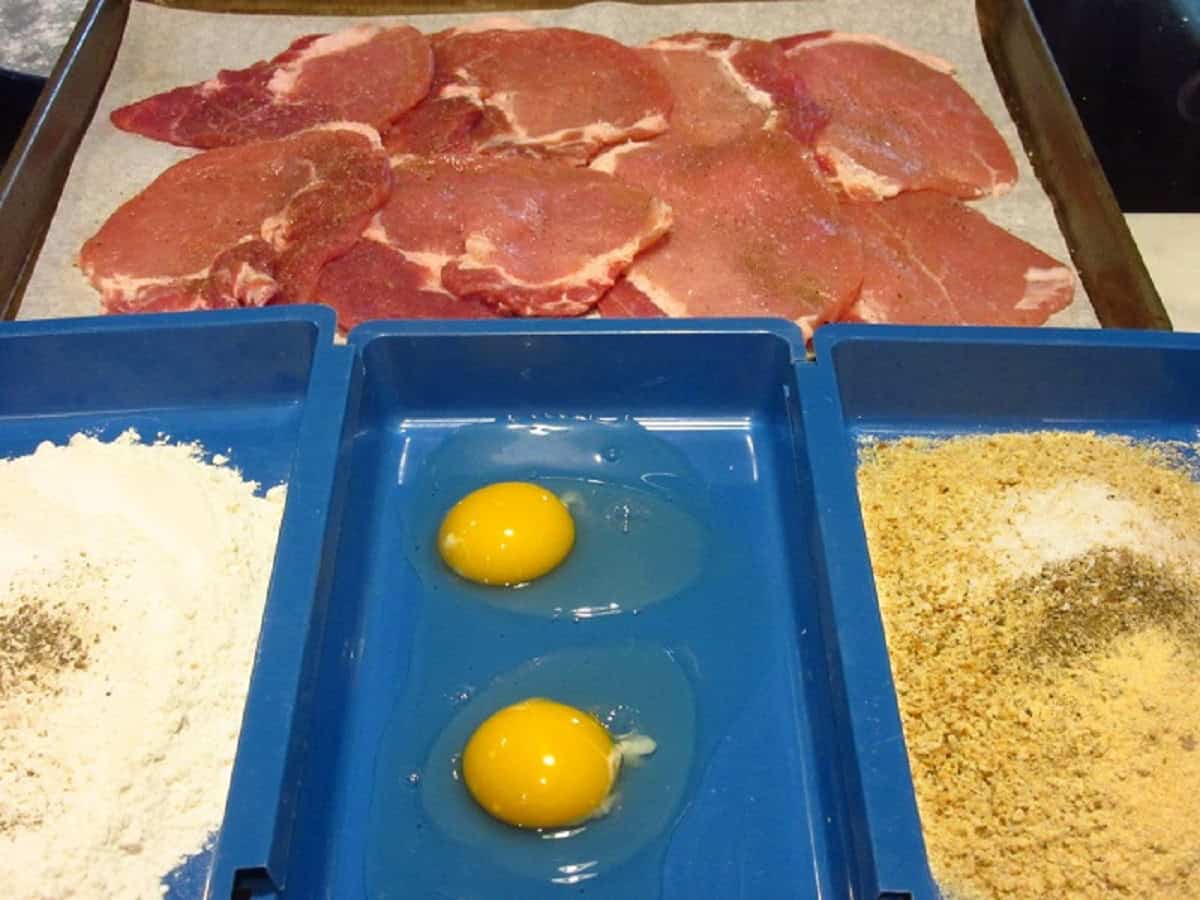 A breading station for making pork schnitzel.