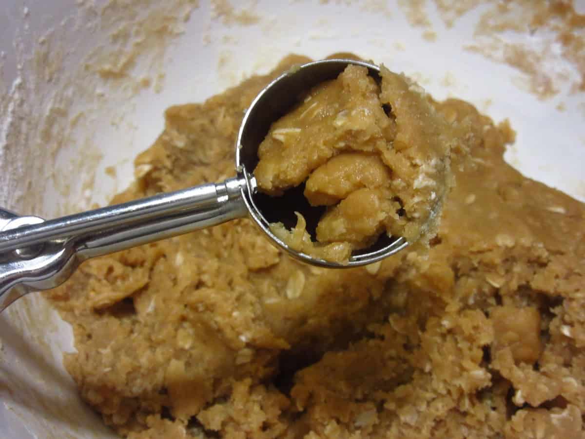 A cookie scoop with raw cookie dough.