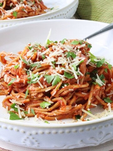 A delicious serving of French Spaghetti in a white bowl with a fork.