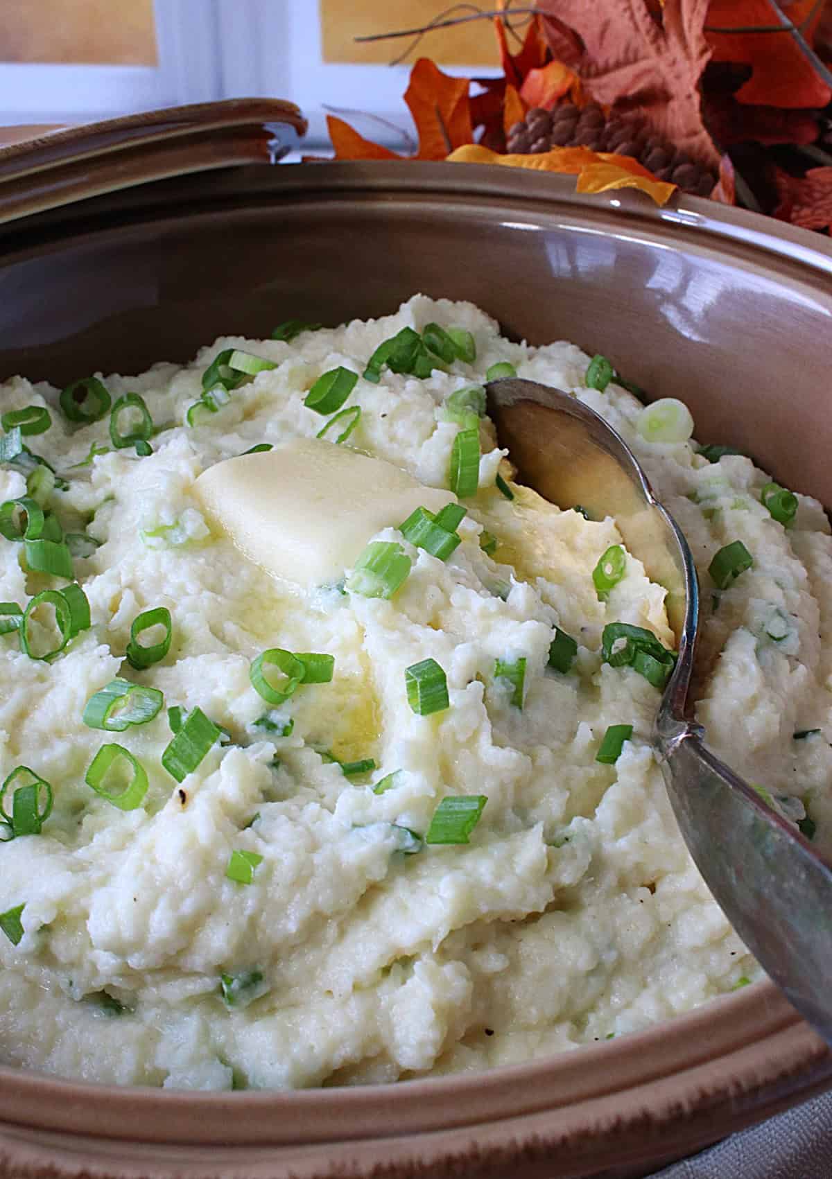 Melting butter on top of a casserole dish of Mashed Parsnips and Scallions.