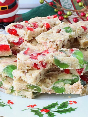 Red and green cherry slices cookies on a pretty holly berry plate.