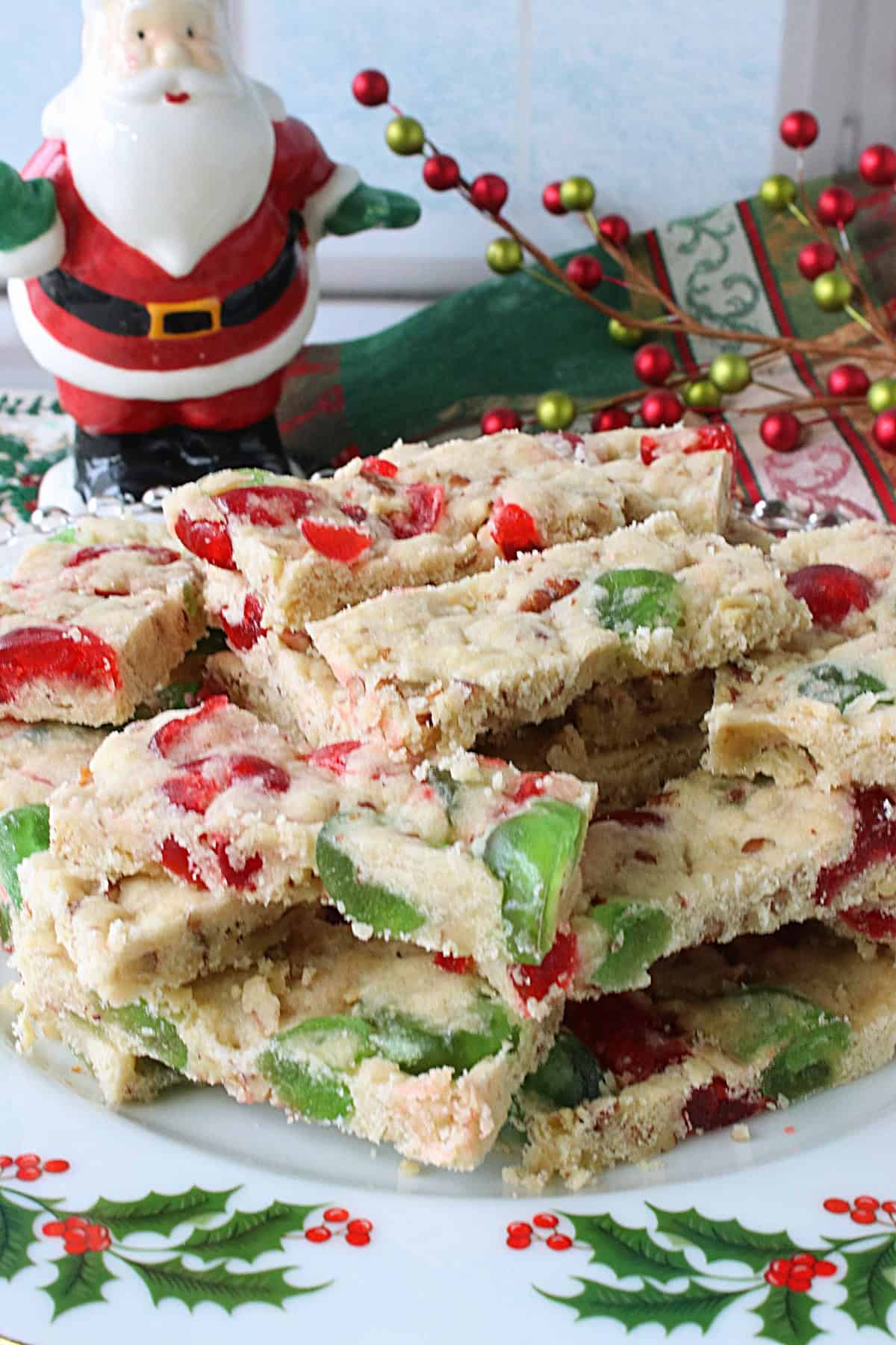 Festive red and green cherry slices on a holiday plate.