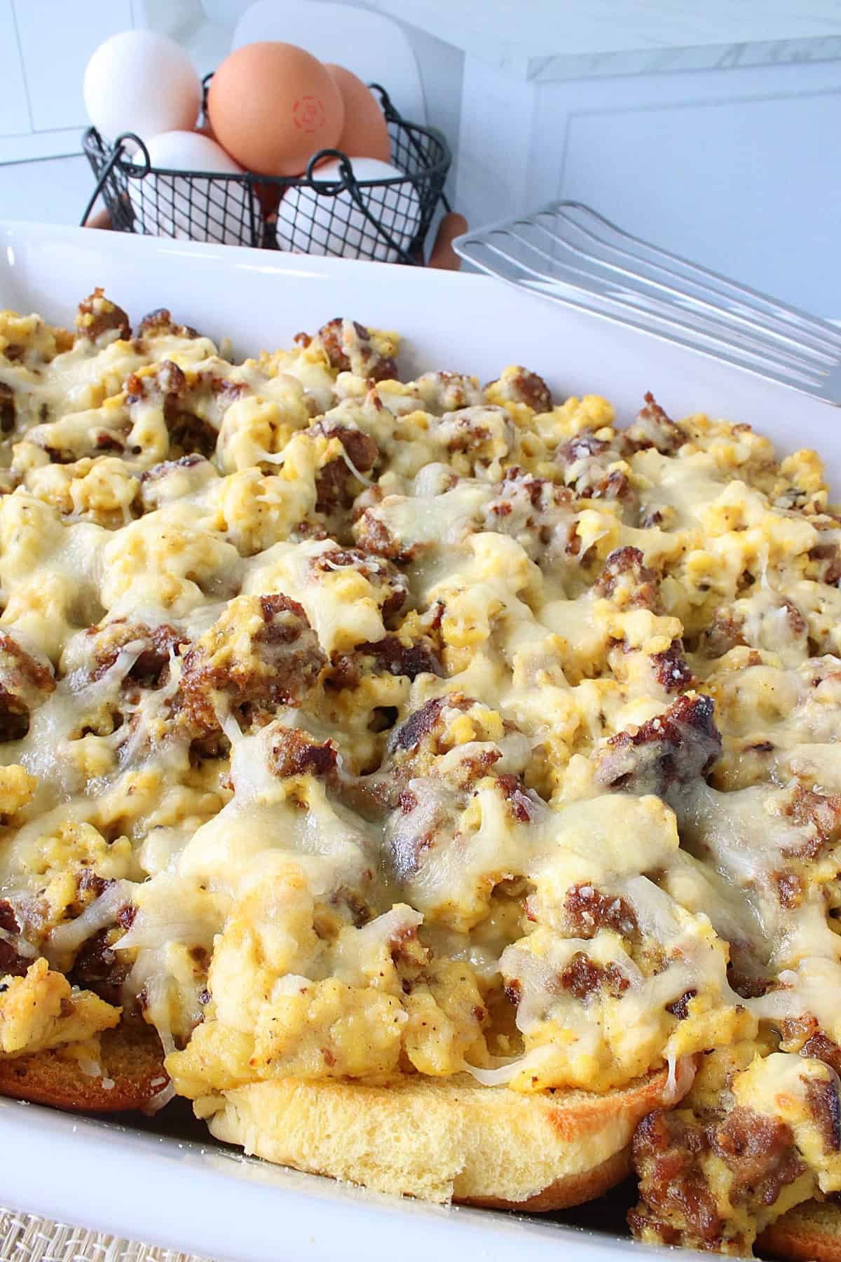 A cheese covered Italian Sausage and Scrambled Egg Casserole.