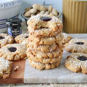 A stack of Peanut Butter and Jelly Potato Chip Cookies dusted with confectioners sugar.