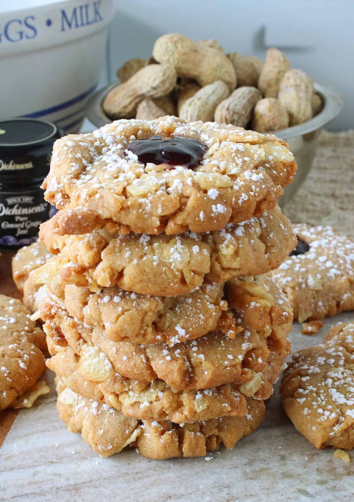 A pretty stack of delicious looking Peanut Butter and Jelly Potato Chip Cookies dusted with confectioners sugar.