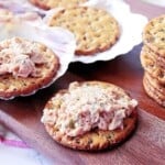 A cracker piled high with baked salmon salad spread.