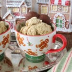 A cute cup with gingerbread men filled with gingerbread ice cream and a chocolate cookie.