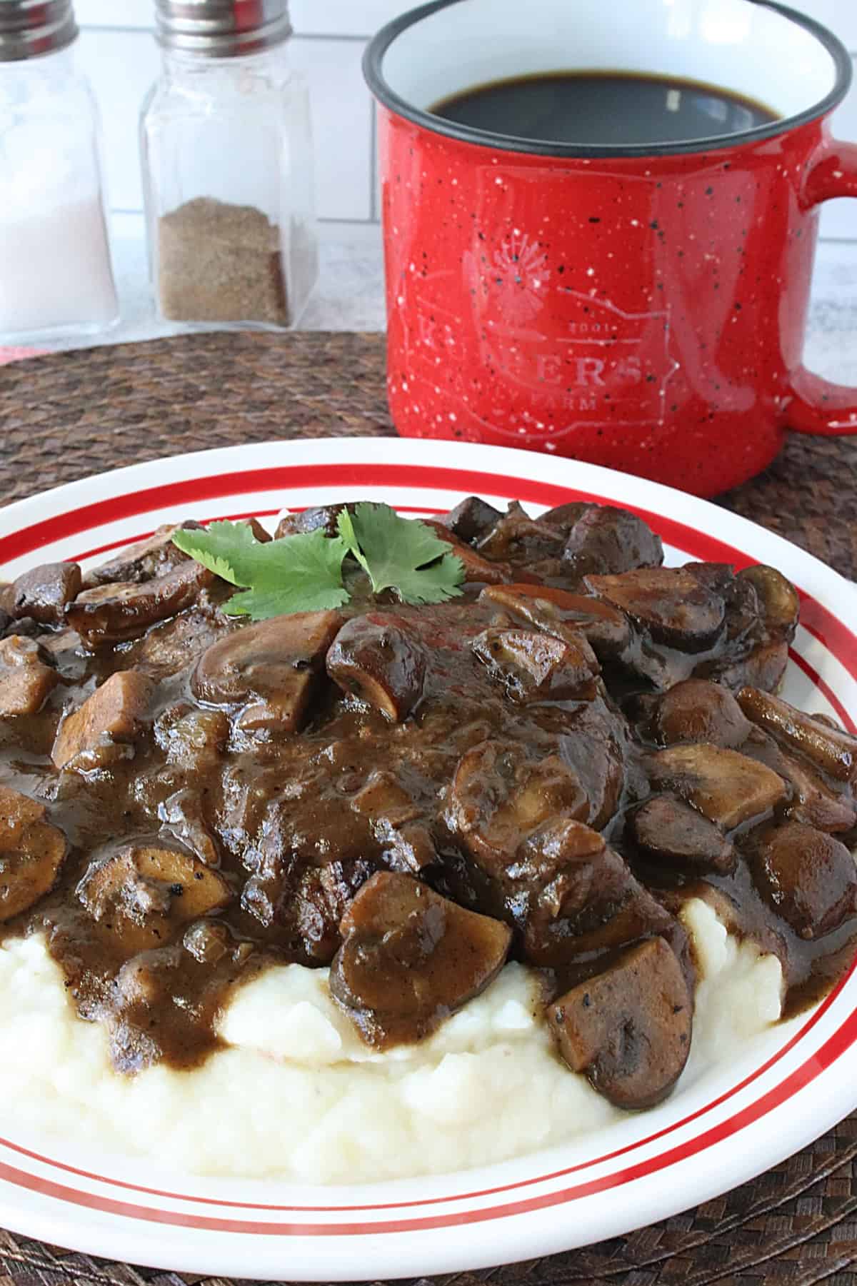 A delicious looking Salisbury Steak covered in a deep brown mushroom gravy.