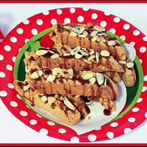 A festive christmas plate filled with Amaretto Coconut Biscotti drizzled with caramel.