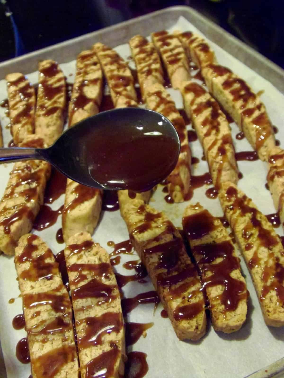 Caramel being drizzled over biscotti cookies.