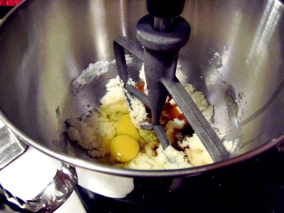 Ingredients in the bowl of a stand mixer for making amaretto coconut biscotti.