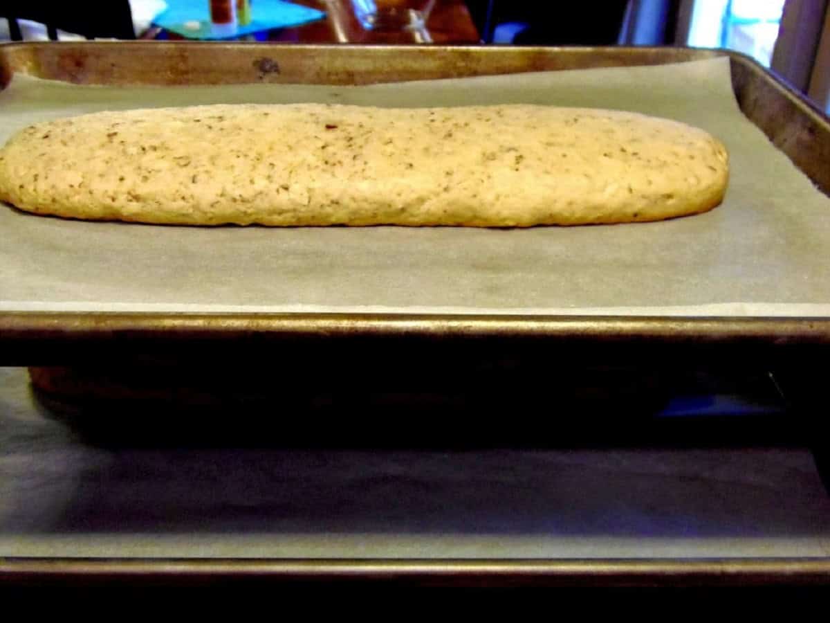 A baked log of biscotti before slicing.
