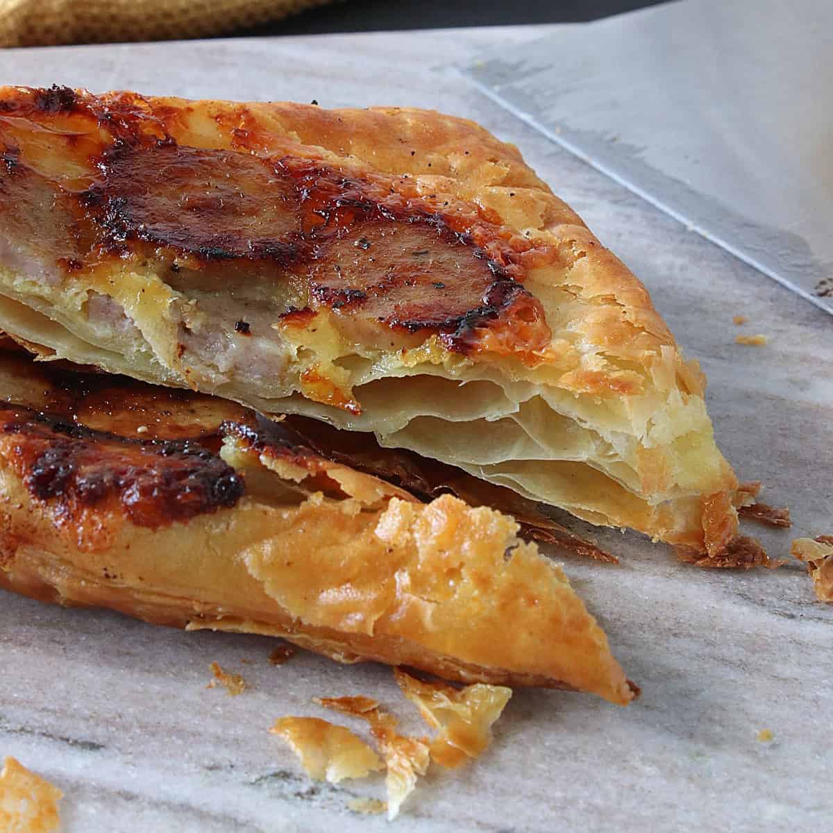 The flaky inside of a bratwurst and cheese sandwich.