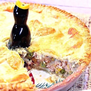 Pork Pot Pie in a pie pan with a slice taken out.