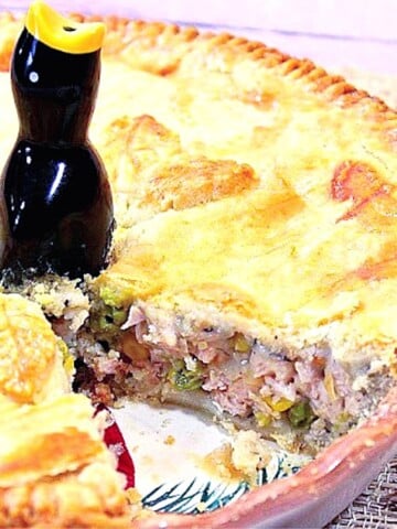Pork Pot Pie in a pie pan with a slice taken out.
