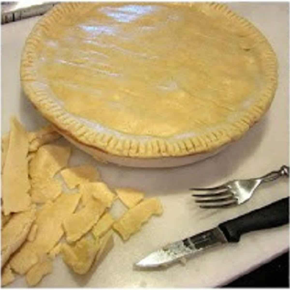 The trimmings of leftover crust from a pork pot pie.